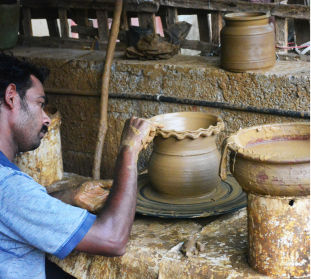 A man is doing pottery in anamala homestay